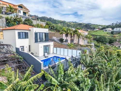 an aerial view of a house with a swimming pool at Blue Ocean Villa in Ponta do Sol