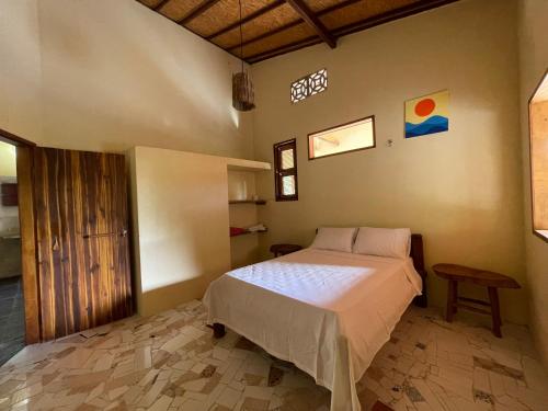 a bedroom with a large bed in a room at Casa na lagoa azul in Cruz