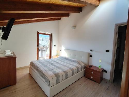 a bedroom with a large bed and a window at CasaSolar Saintchristophe a 2 minuti da Aosta in Aosta