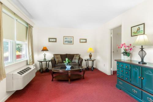 a living room with a couch and a table at Blue Spruce Inn & Suites in Valatie