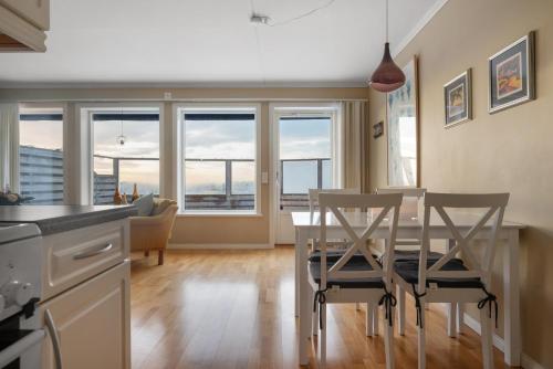 a kitchen and dining room with a table and chairs at Seafront with Terrific View by AJF Dream Living in Fjällbacka