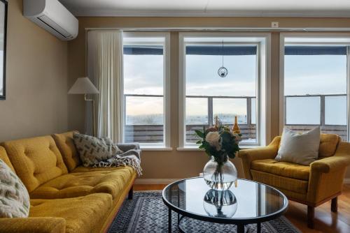 a living room with a couch and a table at Seafront with Terrific View by AJF Dream Living in Fjällbacka