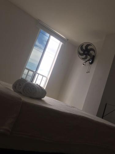 a bedroom with a bed with a large window at San Alejo in Tuluá