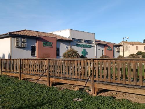 a wooden fence in front of a house at Jolie maison de village in Capendu