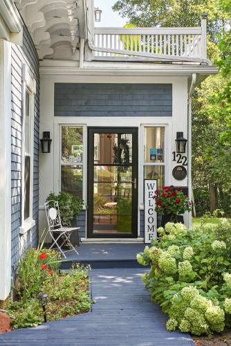 a front porch of a white house with a deck at The Dawson House Bed & Breakfast in Charlottetown