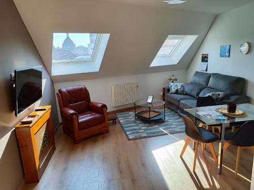 a living room with a couch and a table at El Ático de la Estación in Oviedo
