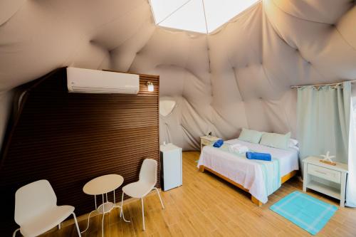 Postel nebo postele na pokoji v ubytování Hotel Don Bululo Camping Lodge