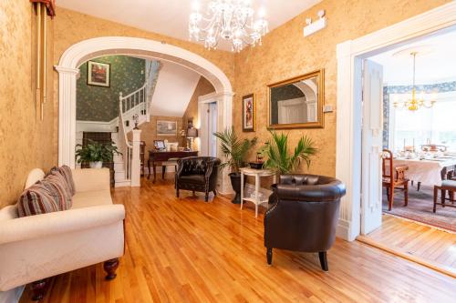 a living room filled with furniture and a dining room at The Dawson House Bed & Breakfast in Charlottetown
