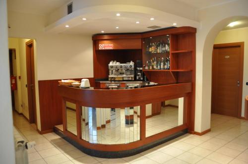 a restaurant with a counter in a room at Hotel Belforte in Varese