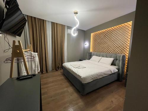 a bedroom with a bed in a room at GRAND JNK Boutique Hotel in Kukës