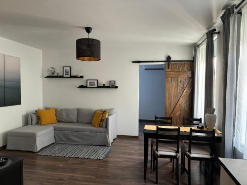 a living room with a couch and a table at Cozy seaside park apartment in Liepāja