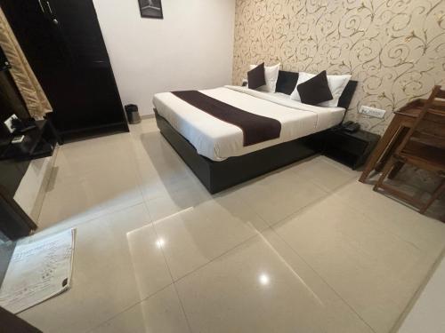 a bedroom with a bed and a sign on the floor at Hotel Life Inn in Jaipur