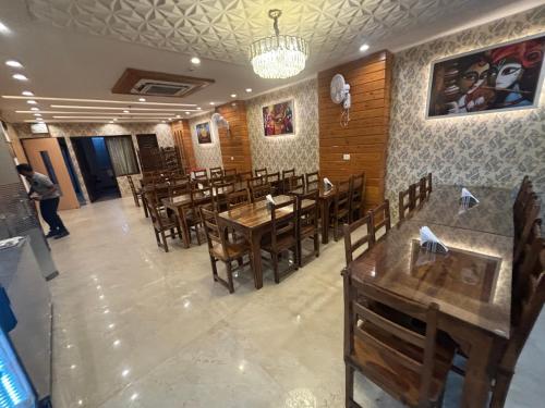 a dining room with wooden tables and chairs at Hotel Life Inn in Jaipur