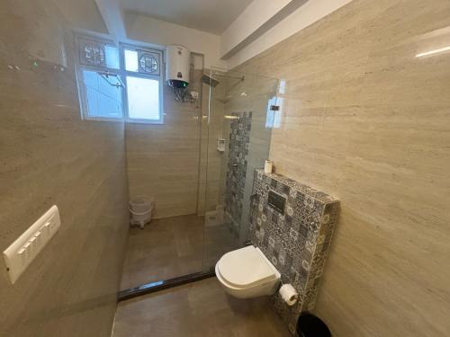 a bathroom with a toilet and a shower at Hotel Life Inn in Jaipur