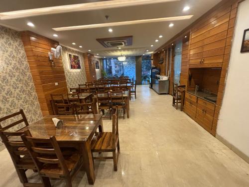 a dining room with wooden tables and chairs at Hotel Life Inn in Jaipur
