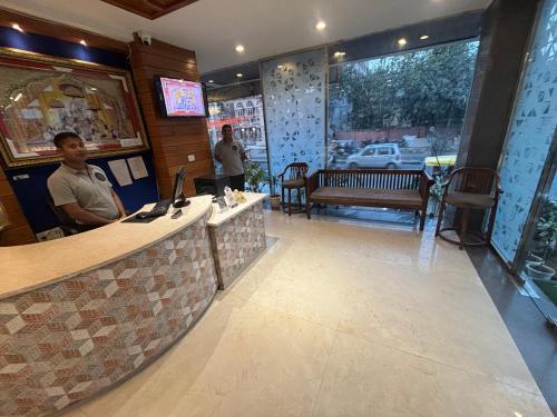 a man standing at a bar in a restaurant at Hotel Life Inn in Jaipur
