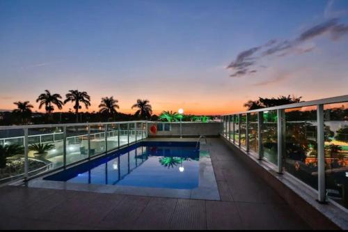 a view of a building with a swimming pool at Apartamento Completo ao lado da lagoa da Pampulha in Belo Horizonte
