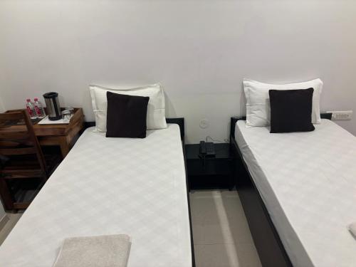 two beds sitting next to each other in a room at Hotel Life Inn in Jaipur