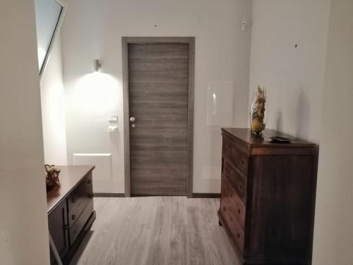 Una habitación con una puerta de madera y una cómoda de madera. en bb45 superior holiday's house CIR 19082053C204471, en Palermo