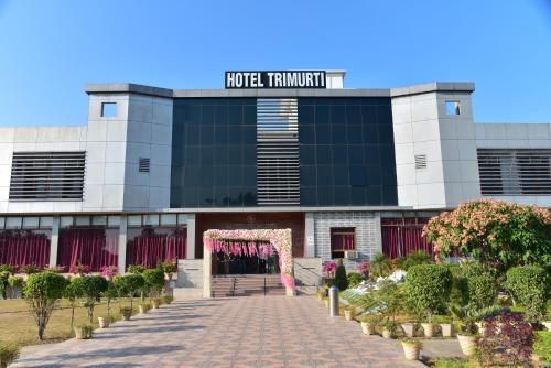 a building with a arch in front of it at Hotel Trimurti in Ayodhya