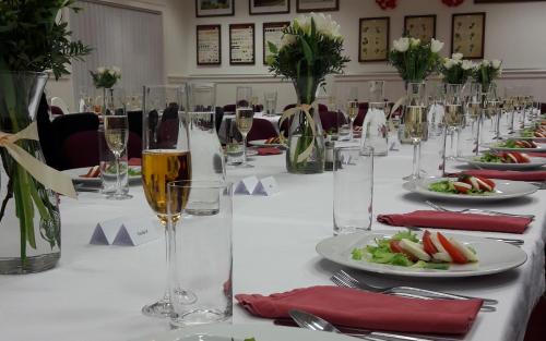 a table with glasses of wine and plates of food at Hotel Berg in Staré Splavy
