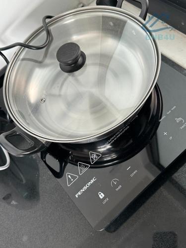 a pan sitting on top of a stove at Urban Suites Georgetown by BNB4U in Jelutong
