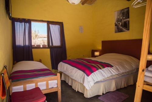 a bedroom with two bunk beds and a window at Hostel La Humahuacasa in Humahuaca