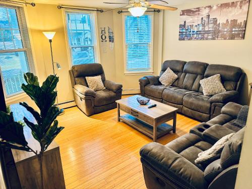 a living room with couches and a coffee table at Bright, Stylish & Cozy 2Bed Unit w/Backyard & Grill Close to NYC! in Haledon