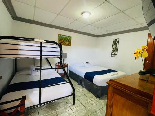a bedroom with two bunk beds and a desk at Hostal Clary in León