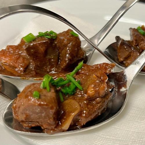 a plate of food with meat and a spoon at Hotel Berg in Staré Splavy