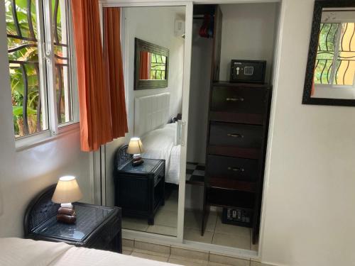 a bedroom with a mirror and a bed and a dresser at Cita del Sol City Apartments in Cabarete