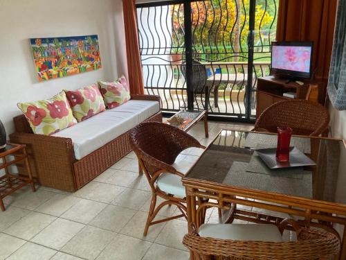 a living room with a couch and a table at Cita del Sol City Apartments in Cabarete