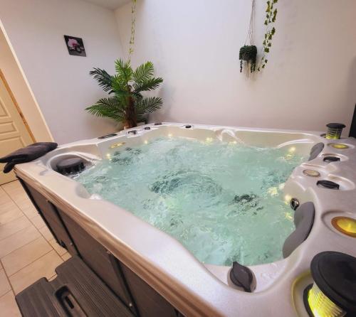 a bath tub filled with water in a bathroom at La marine D'opale in Ambleteuse
