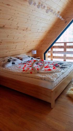 a bed with candy canes on it in a room at Las Lorien - wynajem domków letniskowych in Roczyny