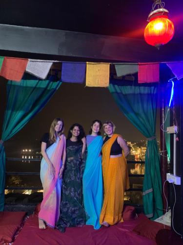 a group of women posing for a picture under a tent at Tamasha Udaipur in Udaipur