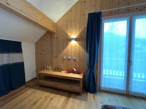 a room with a desk and a large window at Nido di Laura in Santa Maria Maggiore