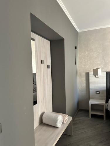 a white room with a bed and a mirror at PRIMA FILA DUE Pemium Guest House in Sanremo