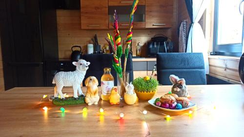 a table with figurines of animals on a table with lights at Las Lorien - wynajem domków letniskowych in Roczyny