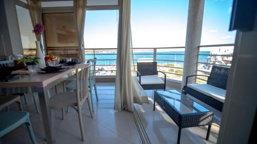 a dining room with a view of the ocean at Mellieha Bay 3 Bedroom Apartment ''Coastal Comfort'' in Mellieħa