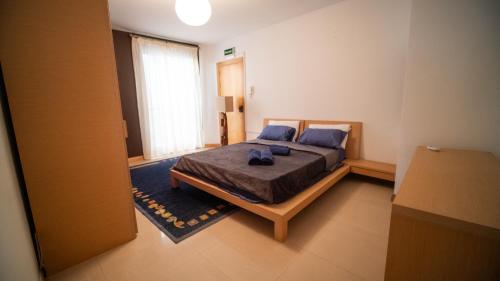 1 dormitorio con 1 cama grande con almohadas azules en Mellieha Bay 3 Bedroom Apartment ''Coastal Comfort'', en Mellieħa