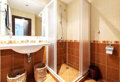 a bathroom with a sink and a shower at Bansko Ski & Relax Apartment in Bansko