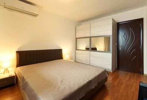 a bedroom with a large bed and a large closet at Bansko Ski & Relax Apartment in Bansko