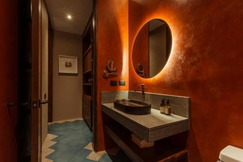 a bathroom with a sink and a mirror at Macondo Arte Oaxaca in Oaxaca City