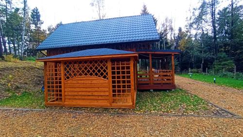 a smallshed with a roof on top of it at Las Lorien - wynajem domków letniskowych in Roczyny