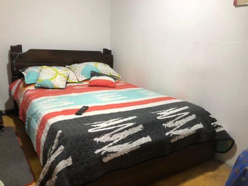 a bedroom with a bed with a zebra blanket and pillows at Hotel El Triangulo in Pitalito