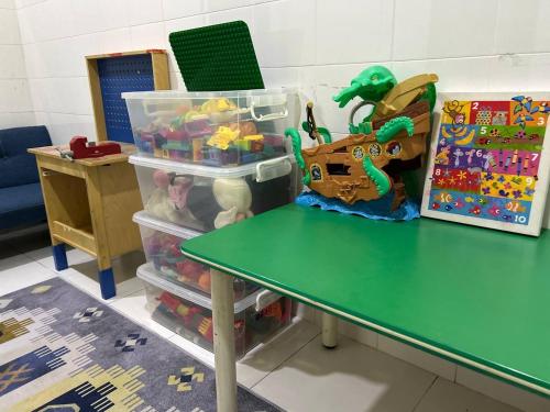 a table in a classroom with a green table at Havengate Homestay in Butterworth