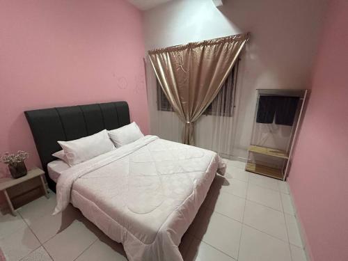 a bedroom with a large bed and a window at Havengate Homestay in Butterworth