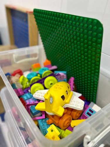 a plastic container filled with toys and a toy figurine at Havengate Homestay in Butterworth