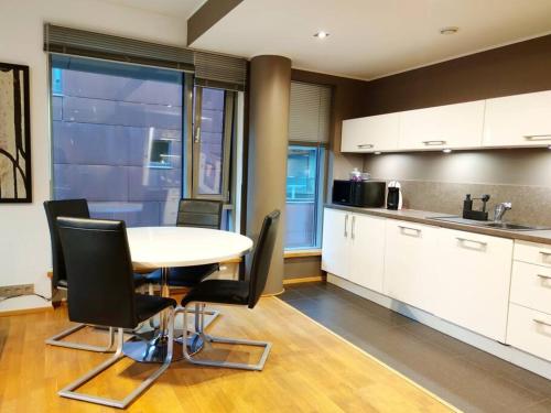 uma cozinha com mesa e cadeiras num quarto em Enjoy luxury and convenience @best area of Tallinn em Talin
