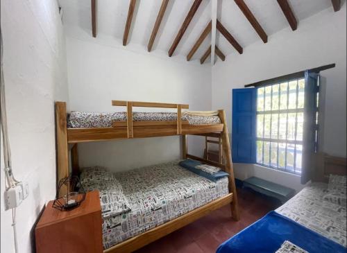 a bedroom with two bunk beds and a window at Hacienda San Francisco in Venecia